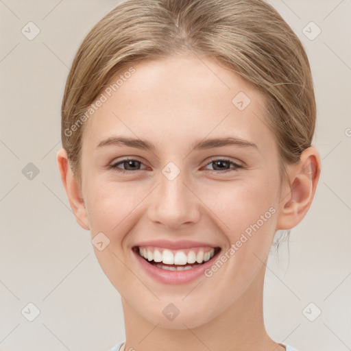 Joyful white young-adult female with short  brown hair and grey eyes