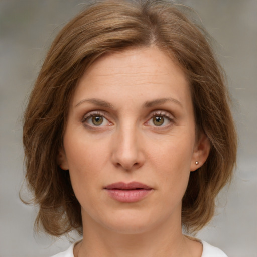 Joyful white young-adult female with medium  brown hair and green eyes