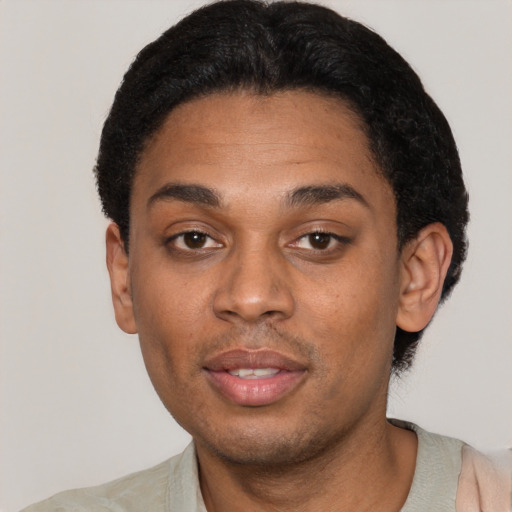 Joyful black young-adult male with short  black hair and brown eyes