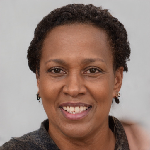 Joyful latino adult female with short  brown hair and brown eyes