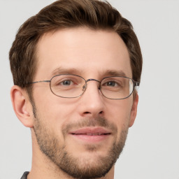 Joyful white adult male with short  brown hair and grey eyes