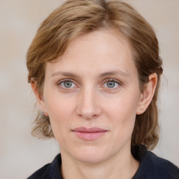 Joyful white young-adult female with medium  brown hair and blue eyes