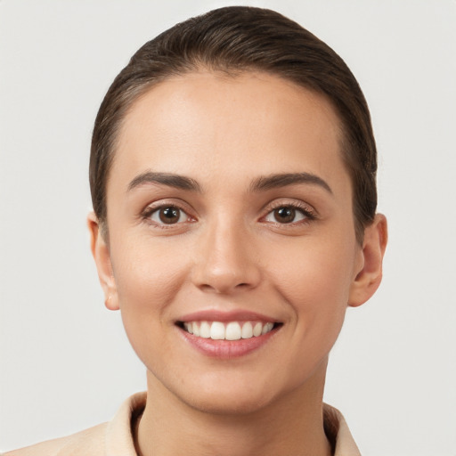 Joyful white young-adult female with short  brown hair and brown eyes