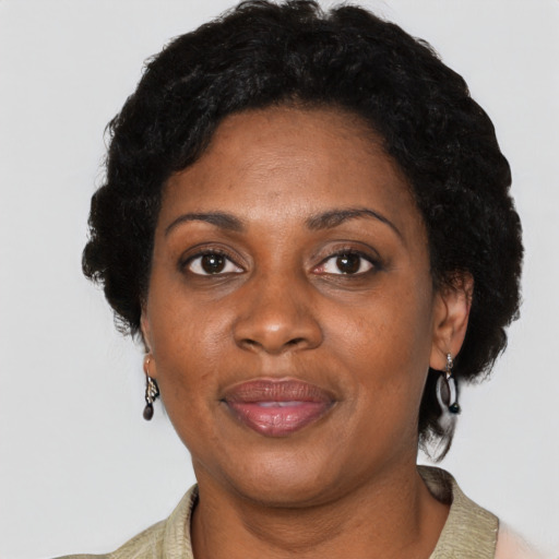 Joyful black adult female with short  black hair and brown eyes