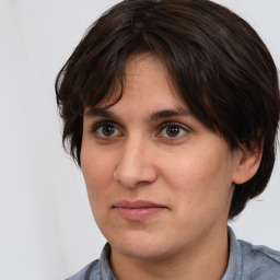 Joyful white adult female with medium  brown hair and brown eyes