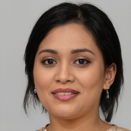 Joyful asian young-adult female with medium  black hair and brown eyes