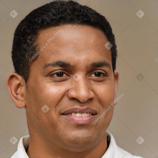 Joyful latino adult male with short  brown hair and brown eyes