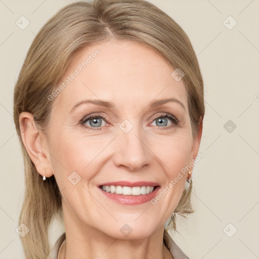 Joyful white adult female with medium  brown hair and blue eyes