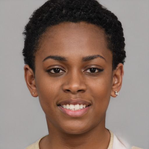 Joyful black young-adult female with short  black hair and brown eyes