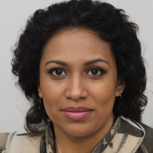 Joyful black young-adult female with medium  brown hair and brown eyes