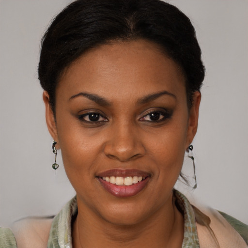 Joyful black young-adult female with short  brown hair and brown eyes