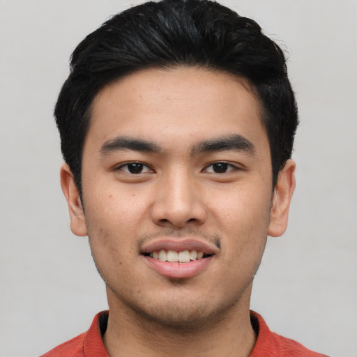 Joyful asian young-adult male with short  black hair and brown eyes