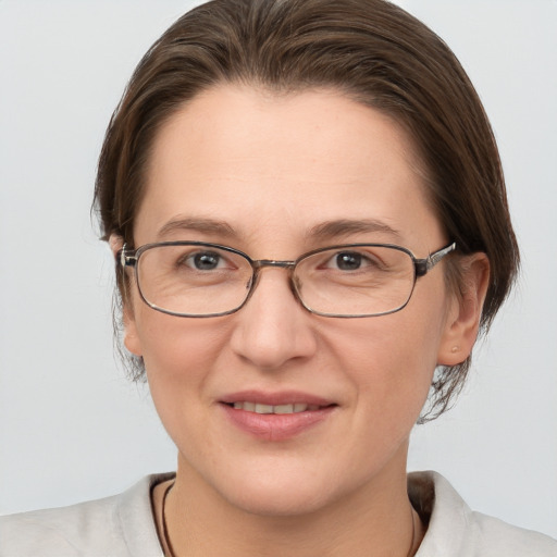 Joyful white adult female with short  brown hair and grey eyes