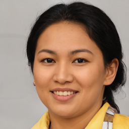 Joyful asian young-adult female with medium  brown hair and brown eyes