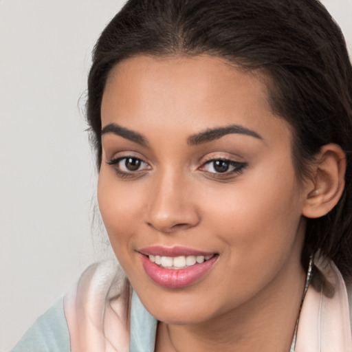 Joyful white young-adult female with long  brown hair and brown eyes