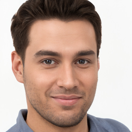 Joyful white young-adult male with short  brown hair and brown eyes