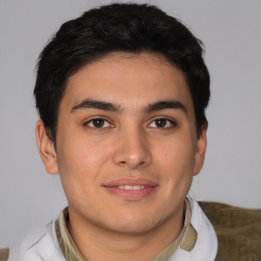 Joyful latino young-adult male with short  brown hair and brown eyes