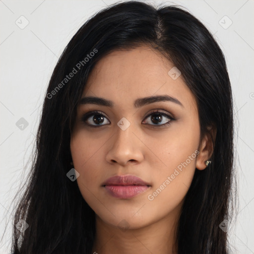 Joyful latino young-adult female with long  black hair and brown eyes