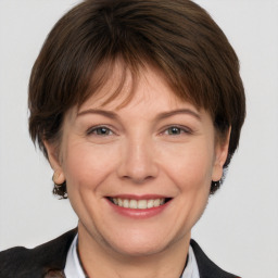 Joyful white adult female with short  brown hair and brown eyes