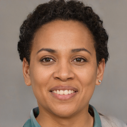 Joyful latino adult female with short  brown hair and brown eyes