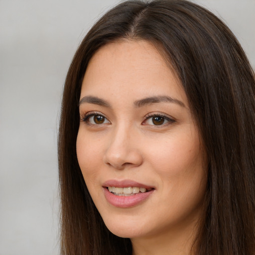 Joyful white young-adult female with long  brown hair and brown eyes