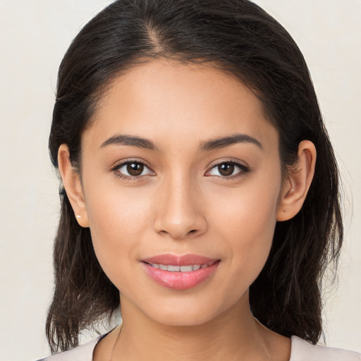 Joyful latino young-adult female with medium  brown hair and brown eyes