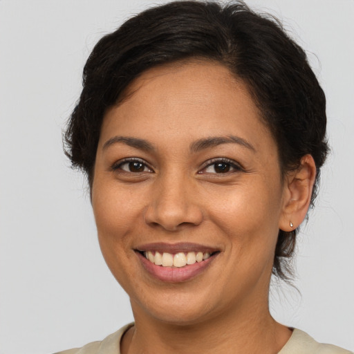 Joyful latino young-adult female with medium  brown hair and brown eyes