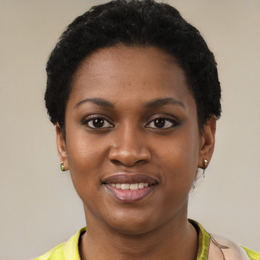 Joyful black young-adult female with short  black hair and brown eyes