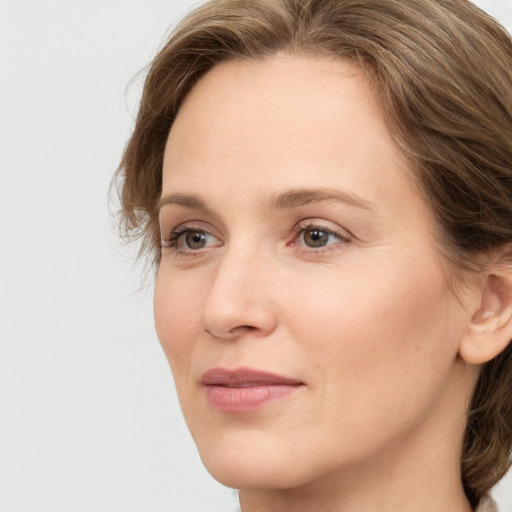 Joyful white young-adult female with medium  brown hair and green eyes