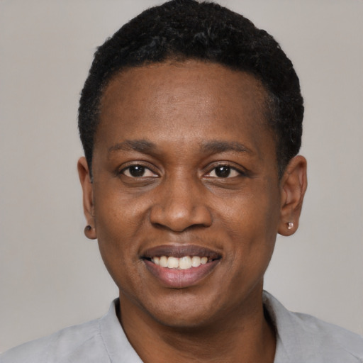 Joyful black young-adult male with short  black hair and brown eyes