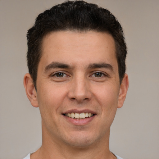 Joyful white young-adult male with short  brown hair and brown eyes