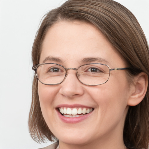 Joyful white adult female with medium  brown hair and grey eyes