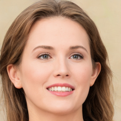 Joyful white young-adult female with long  brown hair and green eyes