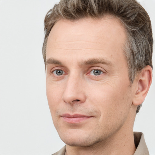 Joyful white adult male with short  brown hair and grey eyes