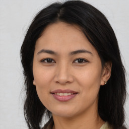 Joyful asian young-adult female with long  brown hair and brown eyes