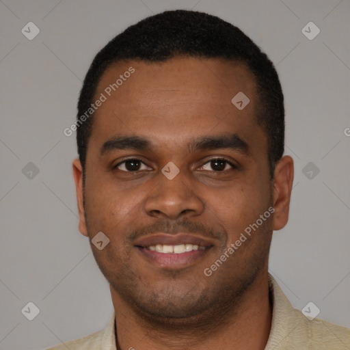 Joyful black young-adult male with short  black hair and brown eyes