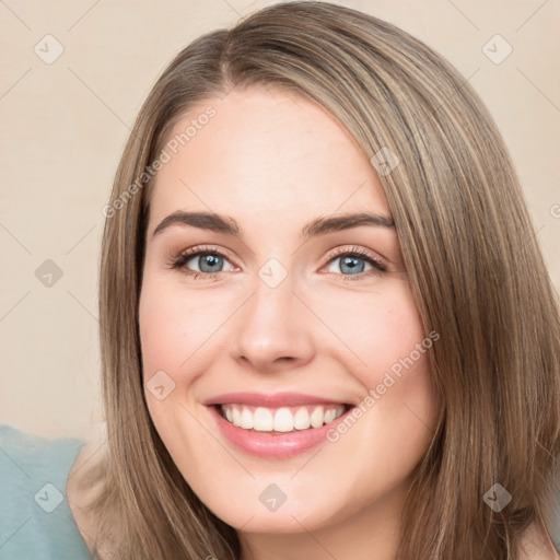 Joyful white young-adult female with long  brown hair and green eyes