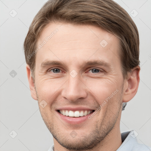 Joyful white young-adult male with short  brown hair and grey eyes