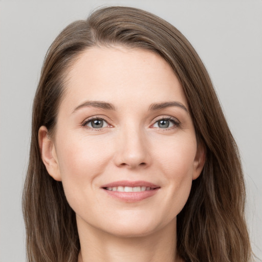 Joyful white young-adult female with long  brown hair and grey eyes