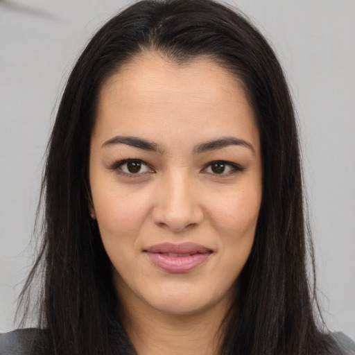 Joyful asian young-adult female with long  brown hair and brown eyes