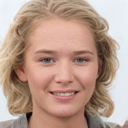 Joyful white young-adult female with medium  brown hair and blue eyes