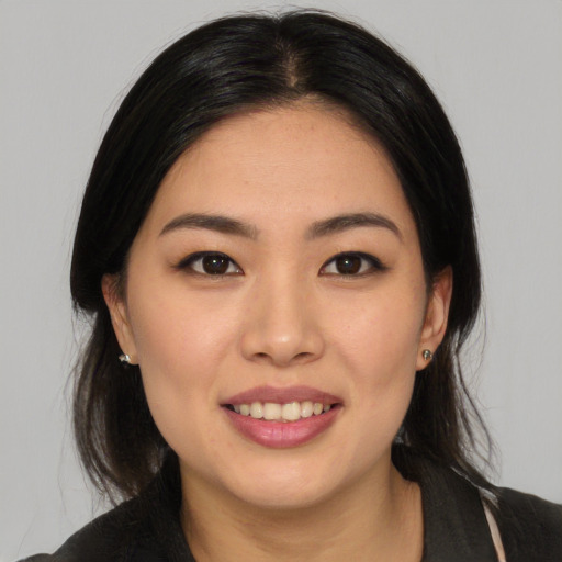 Joyful white young-adult female with medium  black hair and brown eyes