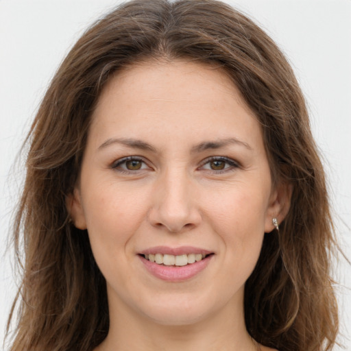 Joyful white young-adult female with long  brown hair and grey eyes