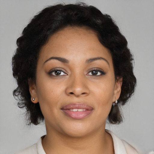 Joyful black young-adult female with medium  brown hair and brown eyes