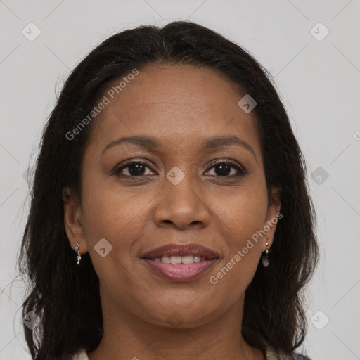 Joyful black adult female with long  brown hair and brown eyes