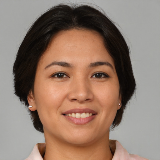 Joyful asian young-adult female with medium  brown hair and brown eyes