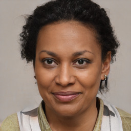 Joyful black adult female with medium  brown hair and brown eyes