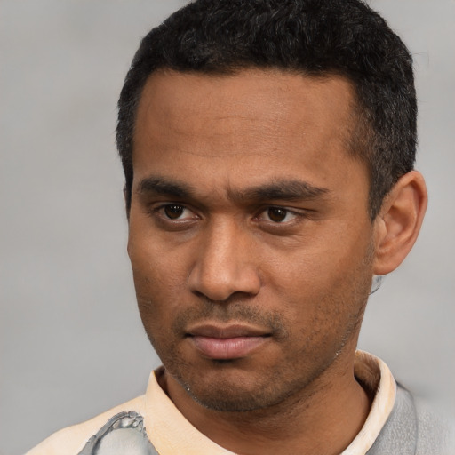 Neutral latino young-adult male with short  black hair and brown eyes