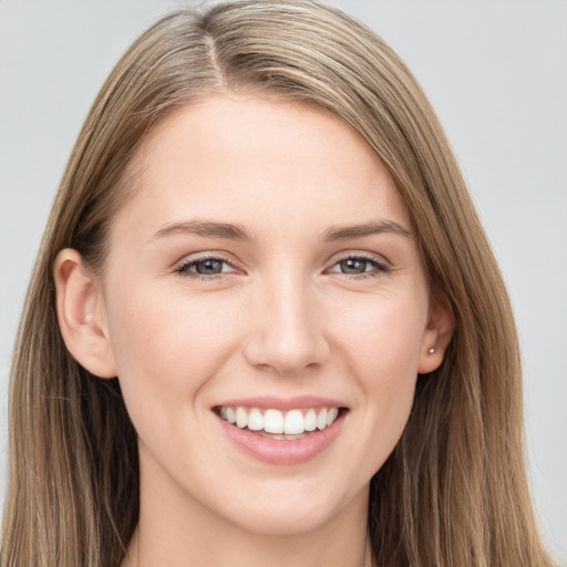 Joyful white young-adult female with long  brown hair and grey eyes