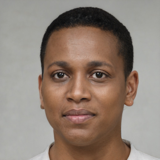 Joyful black young-adult male with short  brown hair and brown eyes